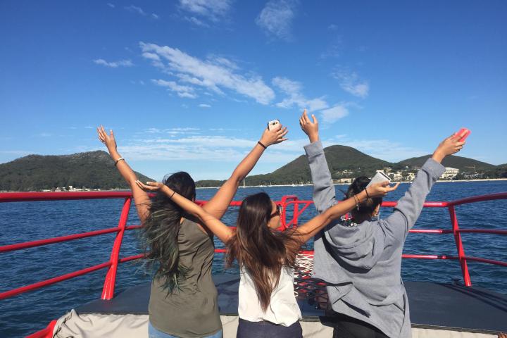 a group of people standing next to a body of water