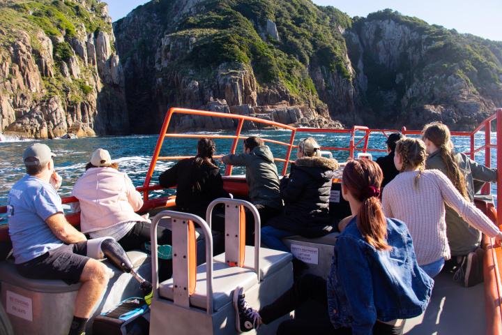 a group of people sitting on top of a mountain