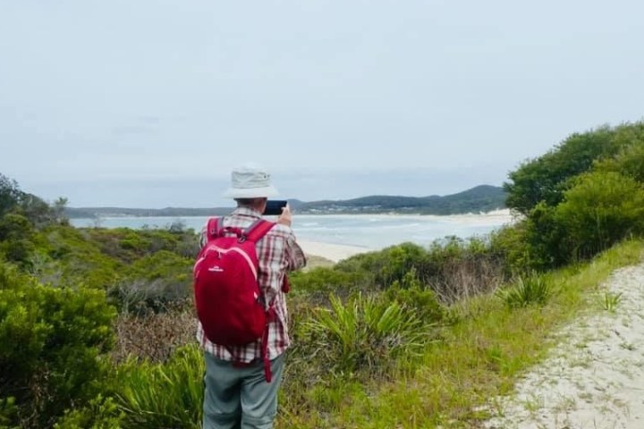 a man standing next to a river