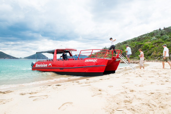 a boat sitting on top of a sandy beach