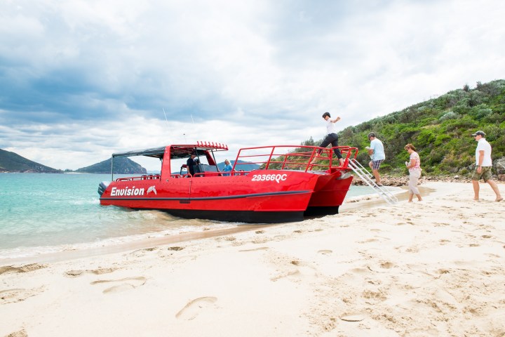 a boat sitting on top of a sandy beach